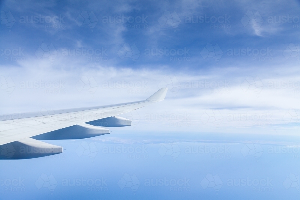 Plane wing over coastal Australian waters on long distance flight - Australian Stock Image