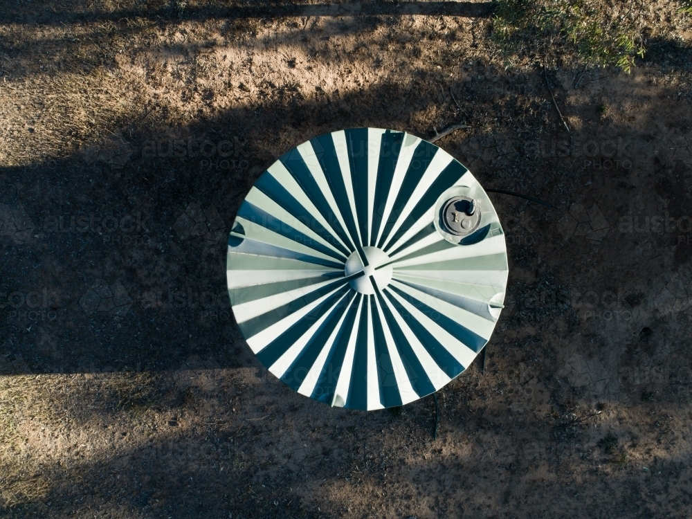 Plastic water storage tank in dry farm paddock - Australian Stock Image