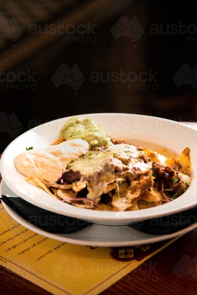 Plate of nachos in a restaurant - Australian Stock Image
