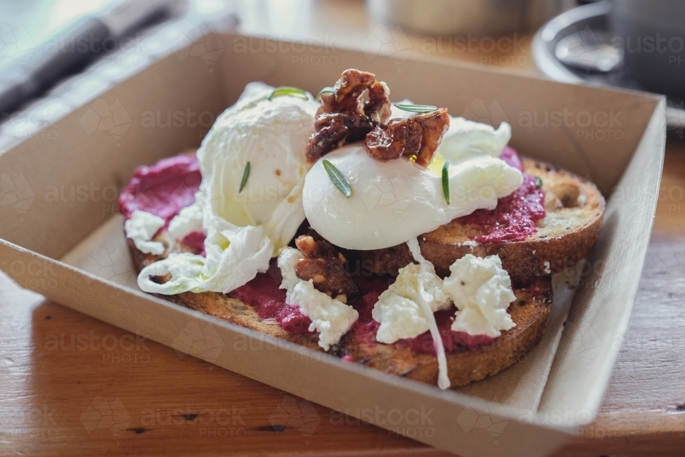 Poached eggs and beetroot puree on wood-fired sourdough toast - Australian Stock Image