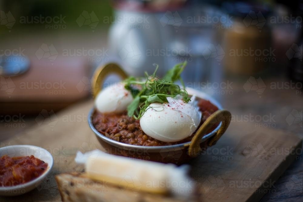 poached eggs shakshouka in cafe - Australian Stock Image
