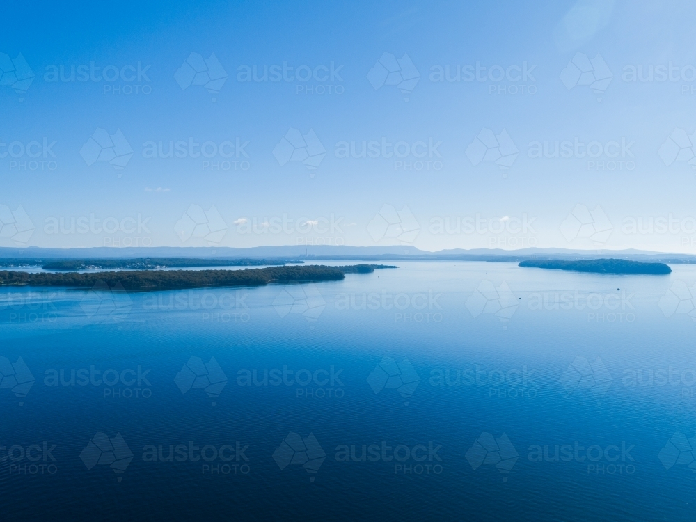 Point Wolstoncroft and pulbah island in blue waters of lake macquarie - Australian Stock Image