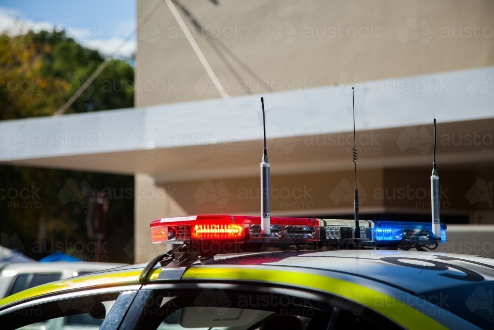 Image of Police car lights flashing red and blue on the roof Austockphoto