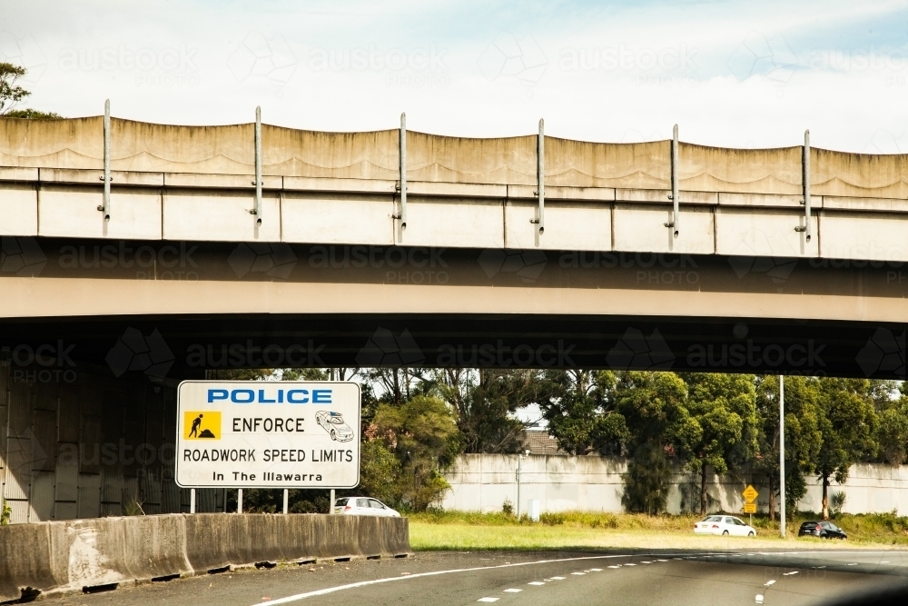 Police enforce roadwork speed limits sign - Australian Stock Image