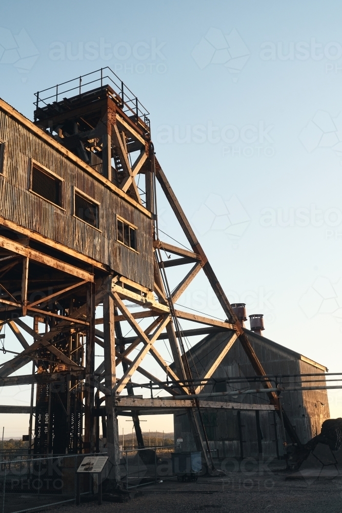 Poppet head mining shaft with golden light - Australian Stock Image