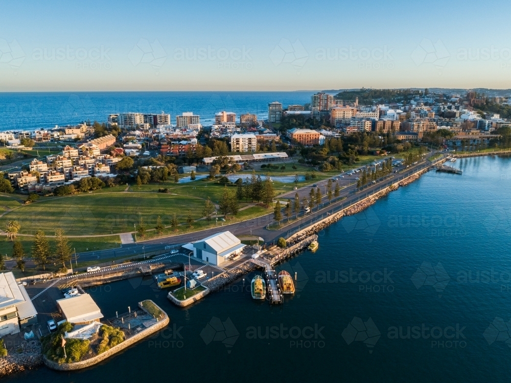 Port authority boats at jetty on Newcastle foreshore with deep blue water at sunset - Australian Stock Image