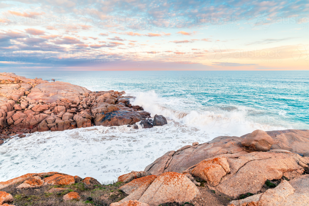 Port Elliot rocky coastline view towards open ocean with big waves at dusk - Australian Stock Image