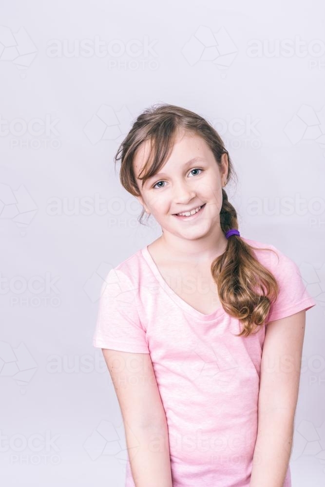 portrait of a 10 year old tween wearing a pink tshirt - Australian Stock Image