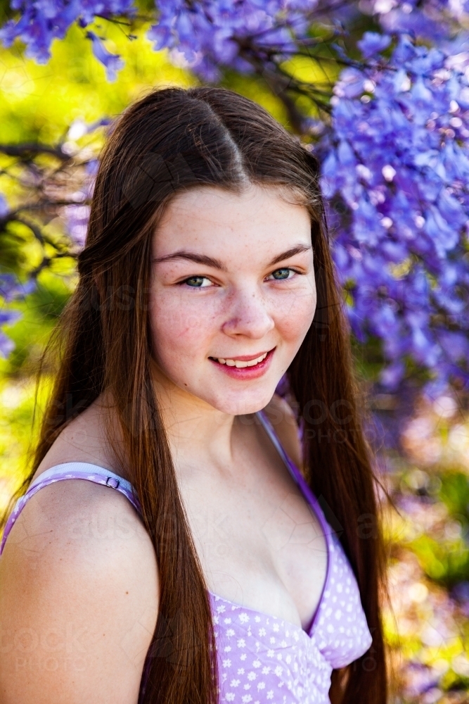 Portrait of a 14yo teen girl with hazel eyes - purple and green - Australian Stock Image