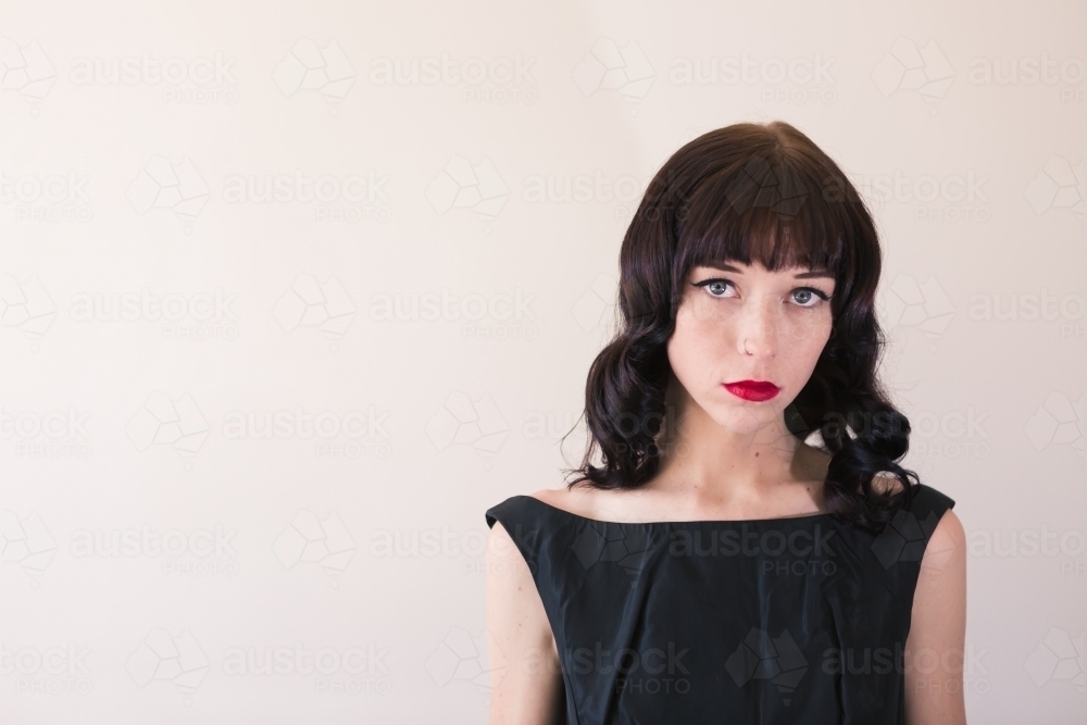 Portrait of a brunette with red lipstick with clear space for text - Australian Stock Image