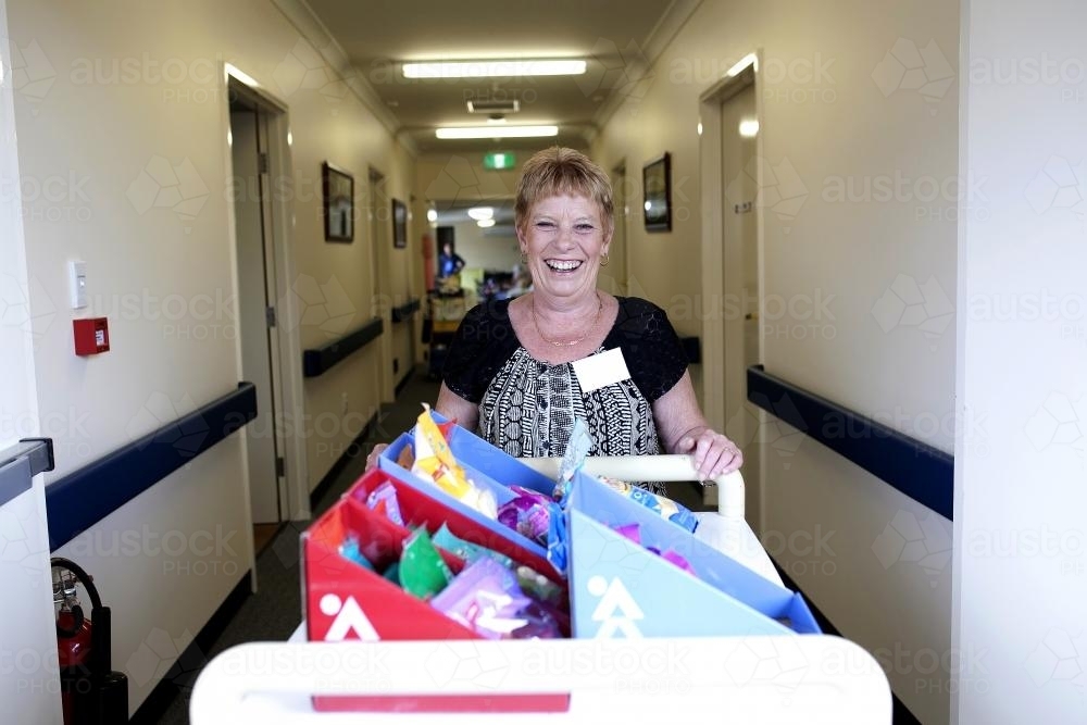 Portrait of a happy female volunteer worker at a regional nursing home - Australian Stock Image