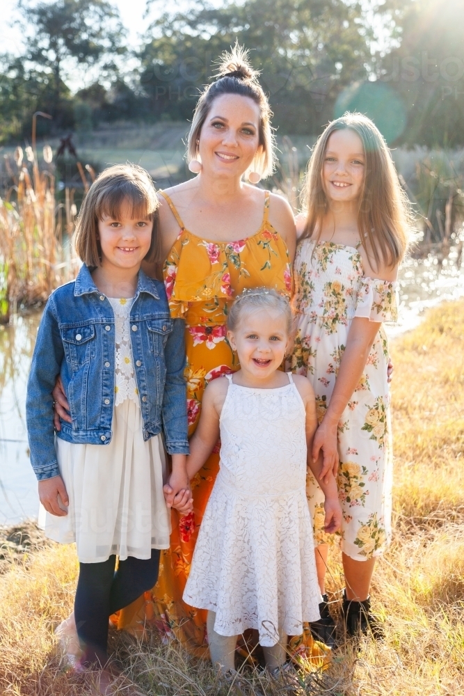 Portrait of a happy mother with her young daughters - Australian Stock Image