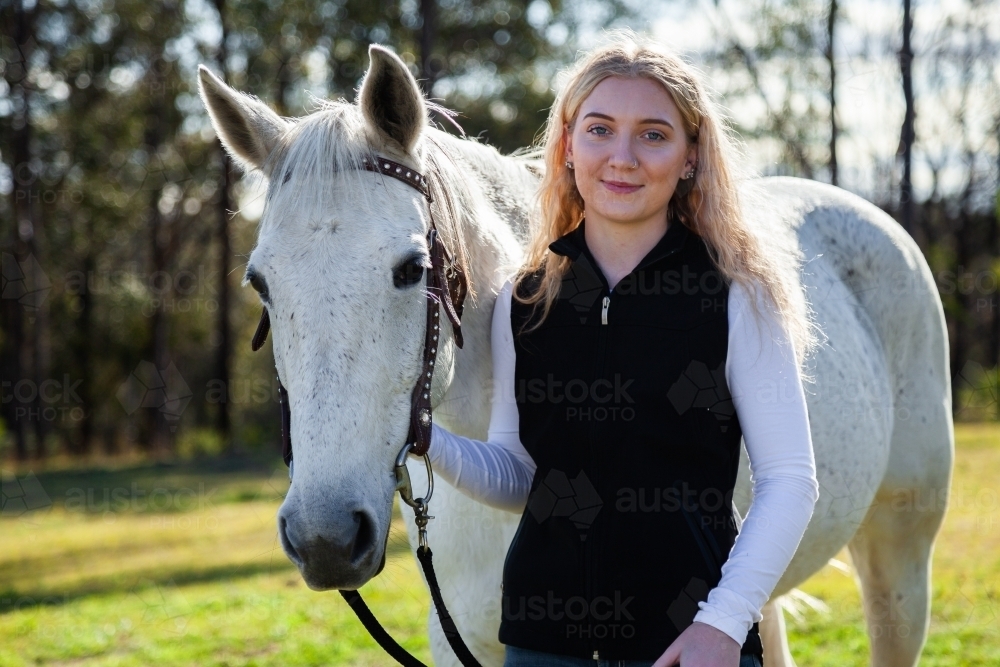Image of Portrait of a happy smiling young aussie woman and her horse ...