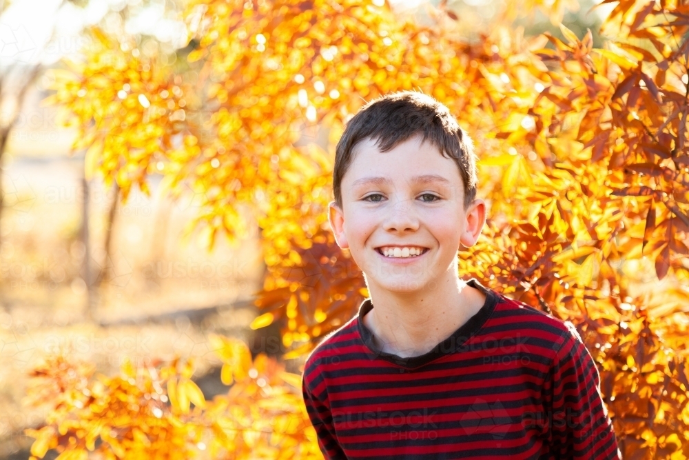 Portrait of a happy ten year old in autumn - Australian Stock Image
