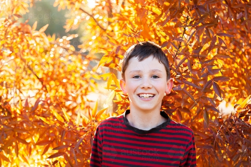 Portrait of a happy ten year old in autumn - Australian Stock Image