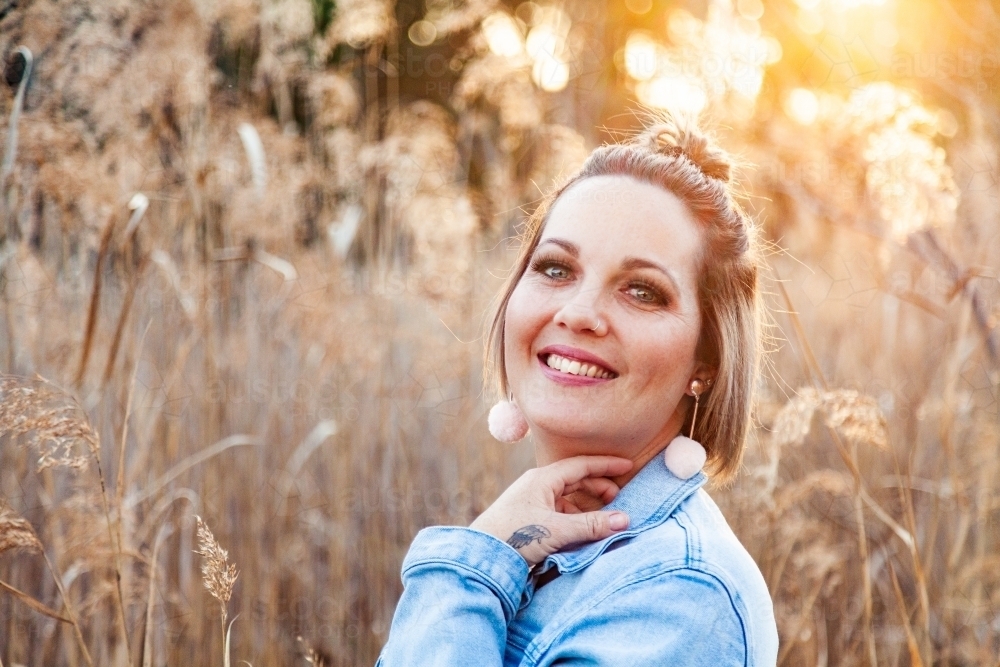 Portrait of a happy thirty something year old woman outside - Australian Stock Image