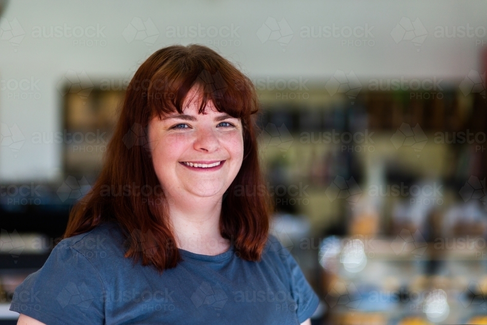 Portrait of a happy woman in her twenties with red hair - Australian Stock Image