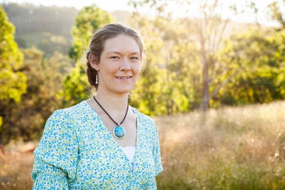 Portrait of a happy woman outside in paddock - Australian Stock Image