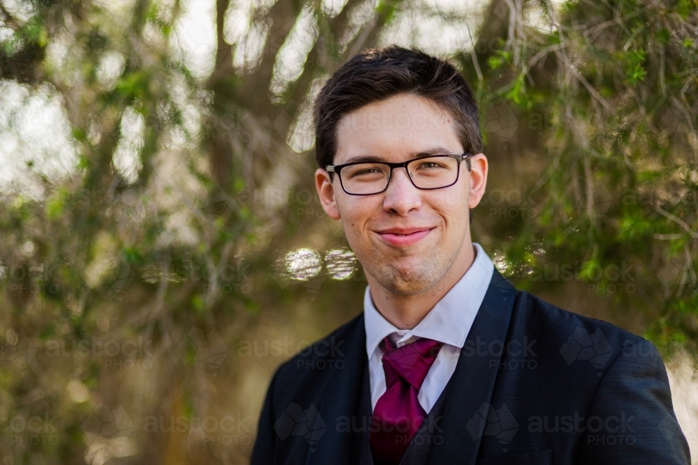 Portrait of a happy young man dressed up in a fancy suit - Australian Stock Image