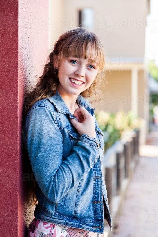 Portrait of a happy young woman in urban setting - Australian Stock Image