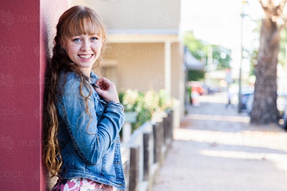 Portrait of a happy young woman in urban setting - Australian Stock Image