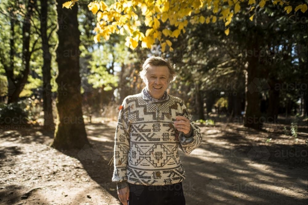 Portrait of a laughing man among trees in the park in winter - Australian Stock Image