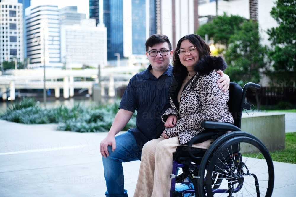 Portrait of a man a woman with a disability in wheel chair sitting outside - Australian Stock Image