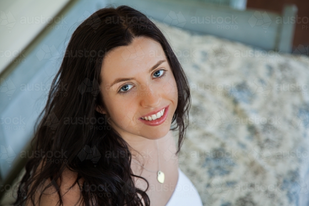 Portrait of a pretty young australian woman with long curly black hair - Australian Stock Image