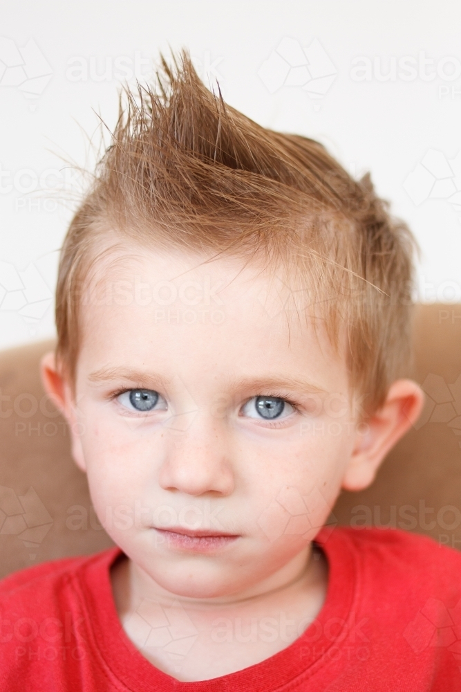 Portrait of a small boy with serious face. - Australian Stock Image