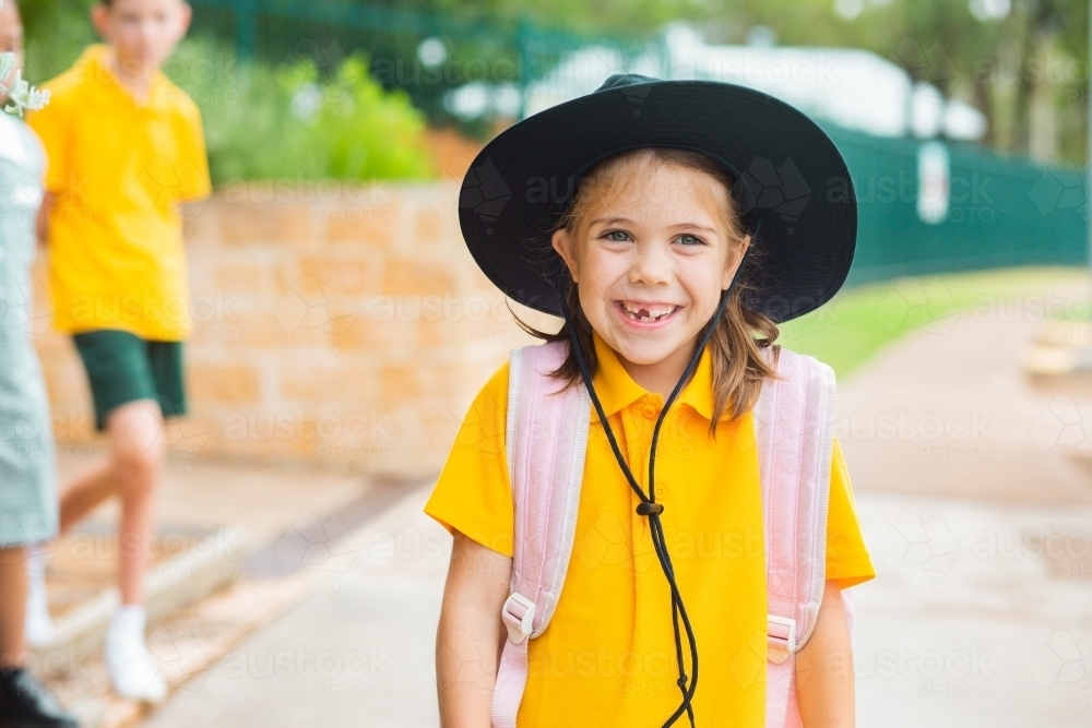 Portrait of a smiling young Australian school girl with bag ready to go back to school - Australian Stock Image