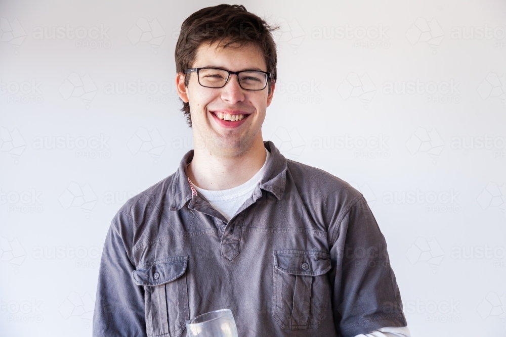 Portrait of a smiling young man on white - Australian Stock Image