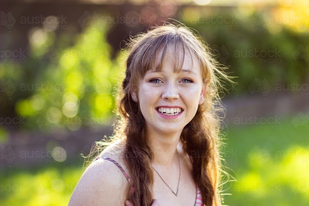 Portrait of a smiling young woman in her late teens - Australian Stock Image