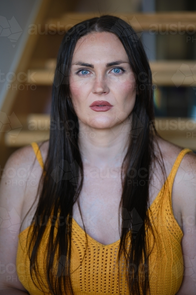 Portrait of a trans woman with long black hair - Australian Stock Image