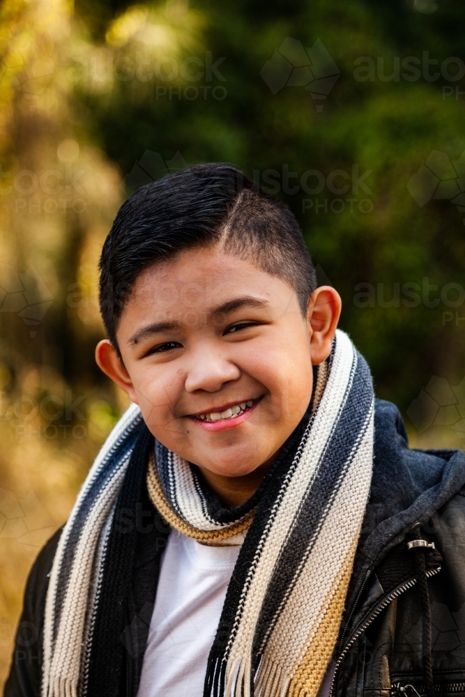 Portrait of a tween boy wearing scarf in winter - Australian Stock Image