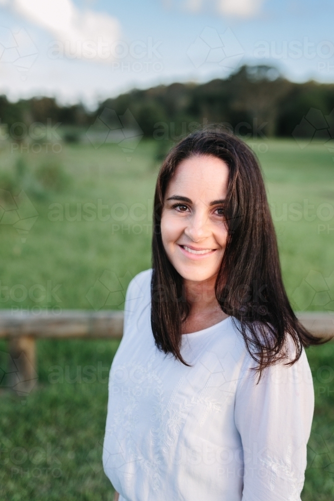 Portrait of a woman outdoors in a field - Australian Stock Image