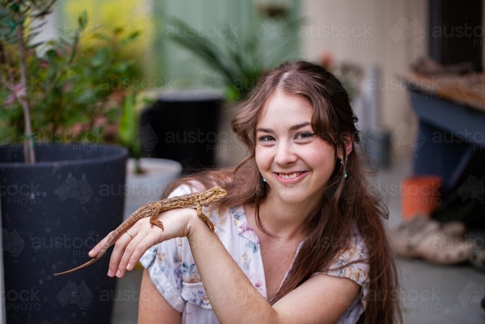Lizard Playing Owner Image of Portrait of a young adult lizard owner with pet reptile ...