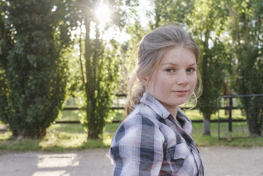Portrait of a young girl at horse riding farm - Australian Stock Image