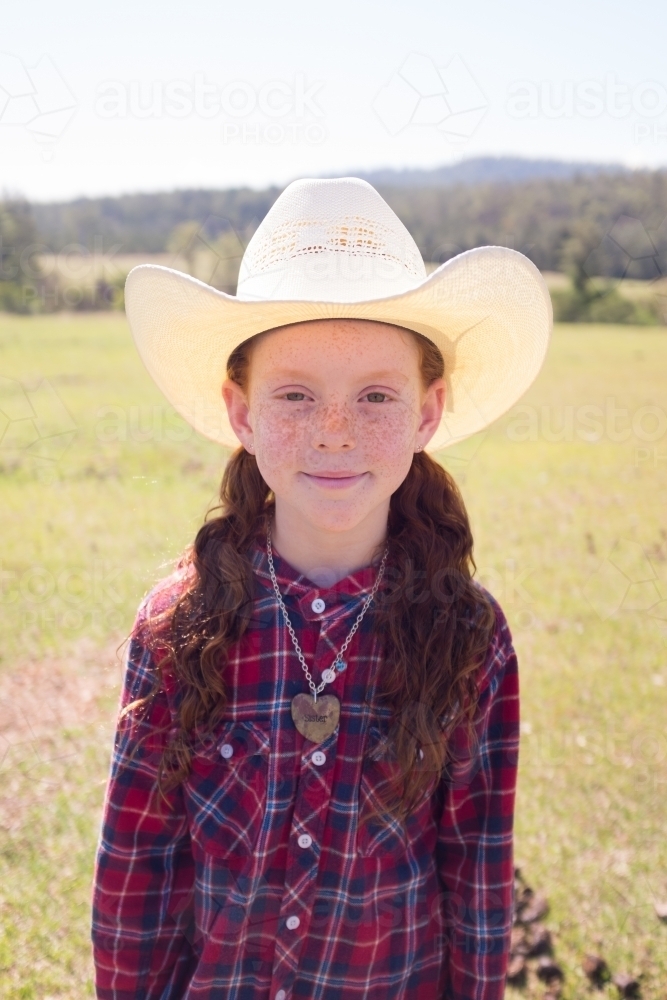Portrait of a young girl in a cowboy hat and check shirt - Australian Stock Image