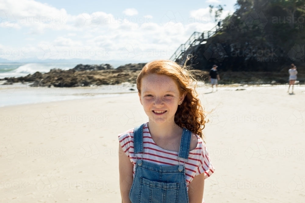 Image of Portrait of a young girl smiling at the beach - Austockphoto