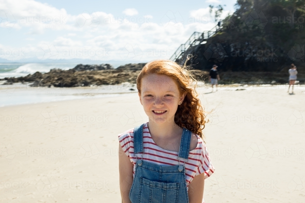 Portrait of a young girl smiling at the beach - Australian Stock Image