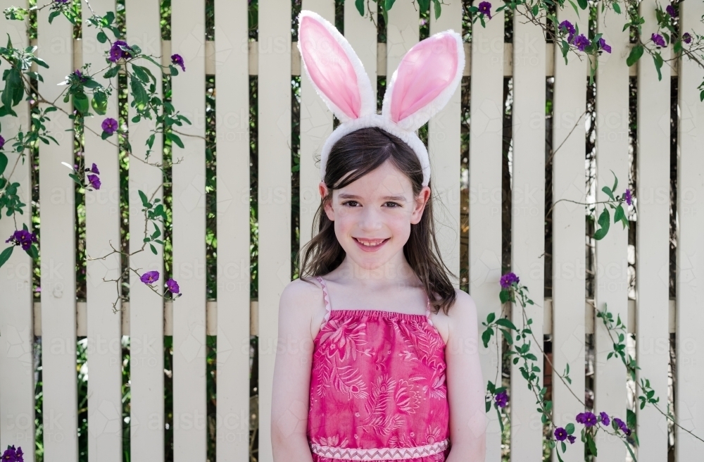 Portrait of a young girl wearing bunny rabbit ears - Australian Stock Image