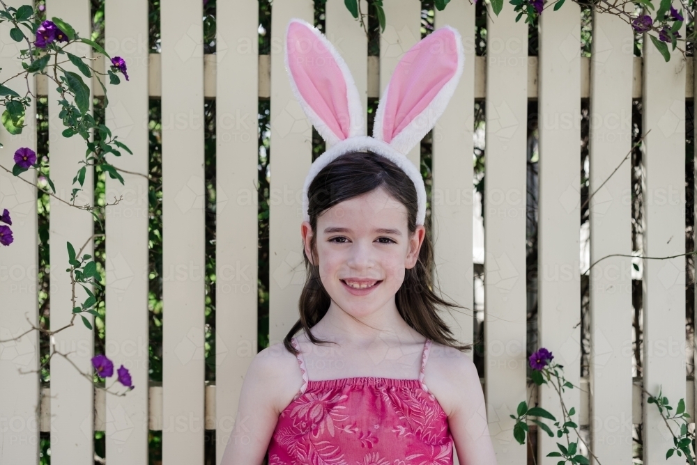 Portrait of a young girl wearing bunny rabbit ears - Australian Stock Image