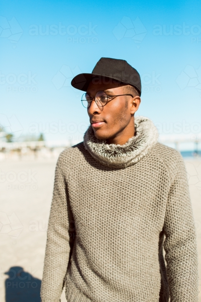 Portrait of a young man standing on the beach - Australian Stock Image