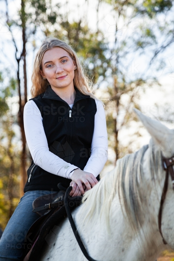 Portrait of a young smiling horserider on her pet horse - Australian Stock Image