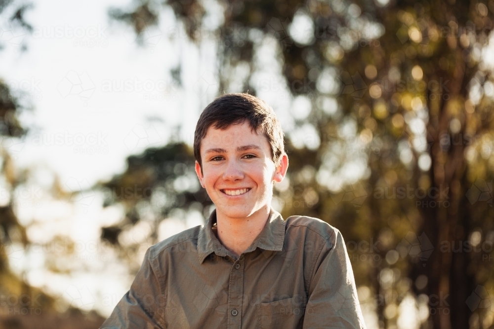 Portrait of a young teen boy in the country with bokeh background - Australian Stock Image