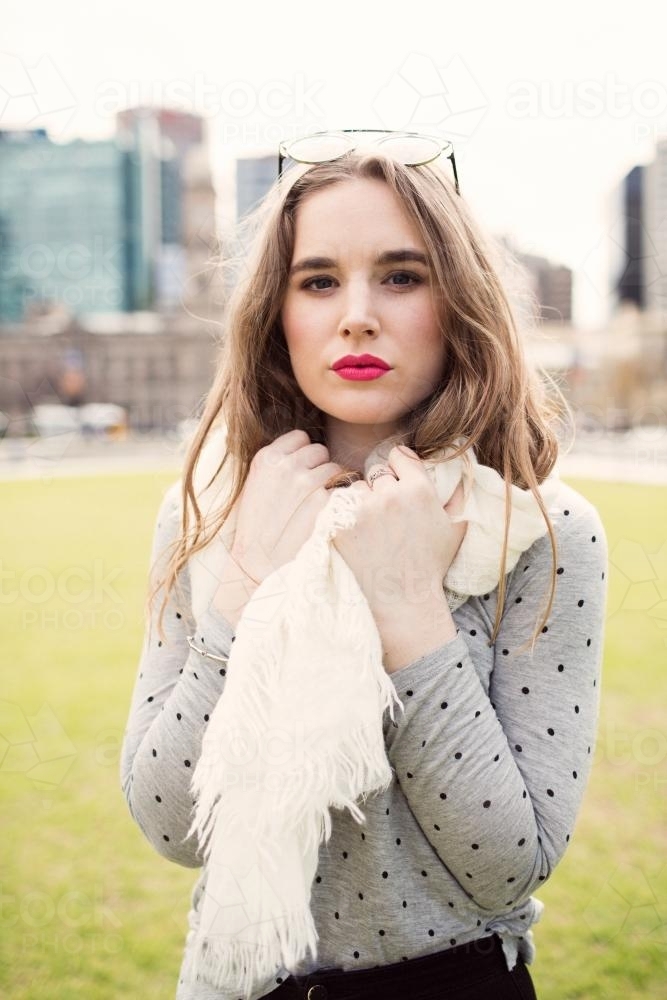 Portrait of a young woman posing wearing a scarf - Australian Stock Image