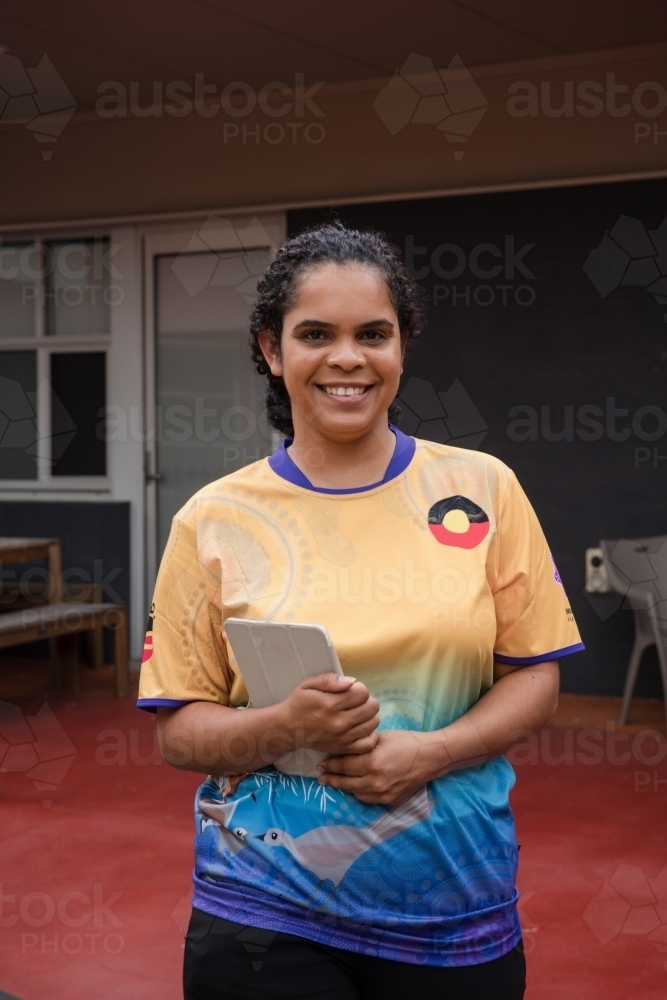 Portrait of Aboriginal woman holding an Ipad - Australian Stock Image