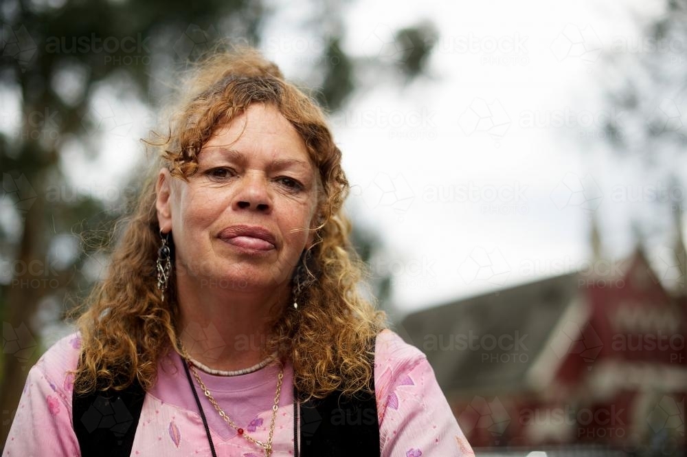 Portrait of Aboriginal Woman with a Pink Top - Australian Stock Image