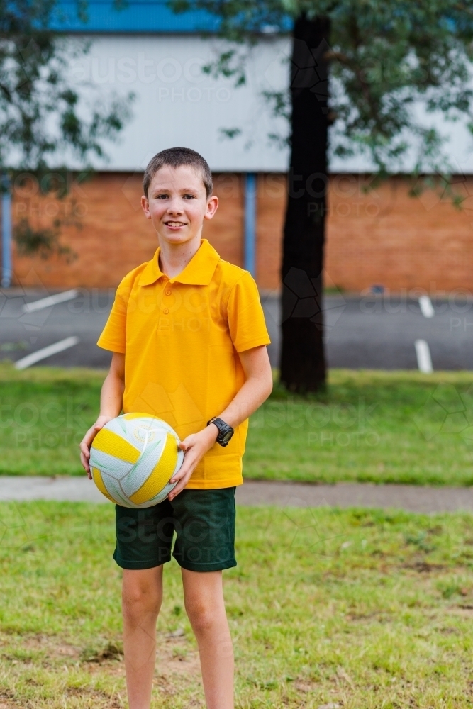 Portrait of Australian primary school child with ball during PE - Australian Stock Image