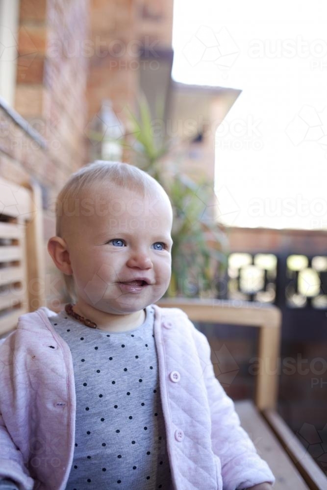 Portrait of baby girl looking away - Australian Stock Image